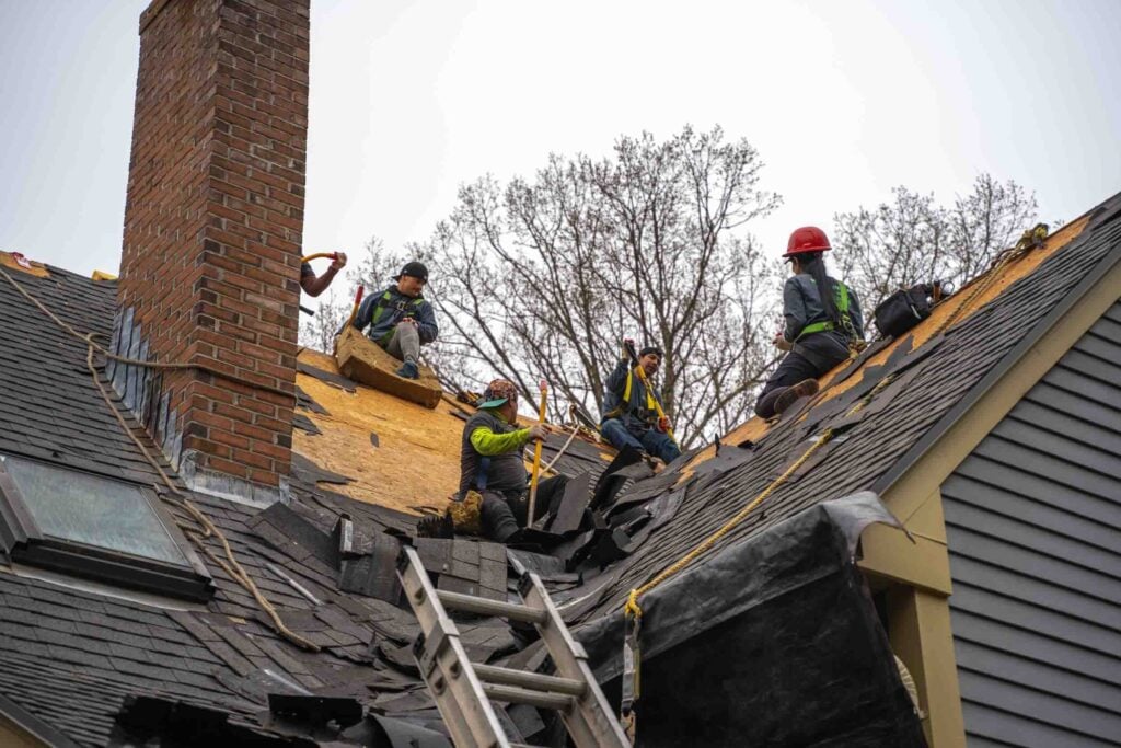 Valley Roofing and Restoration shingles roofing workers removing