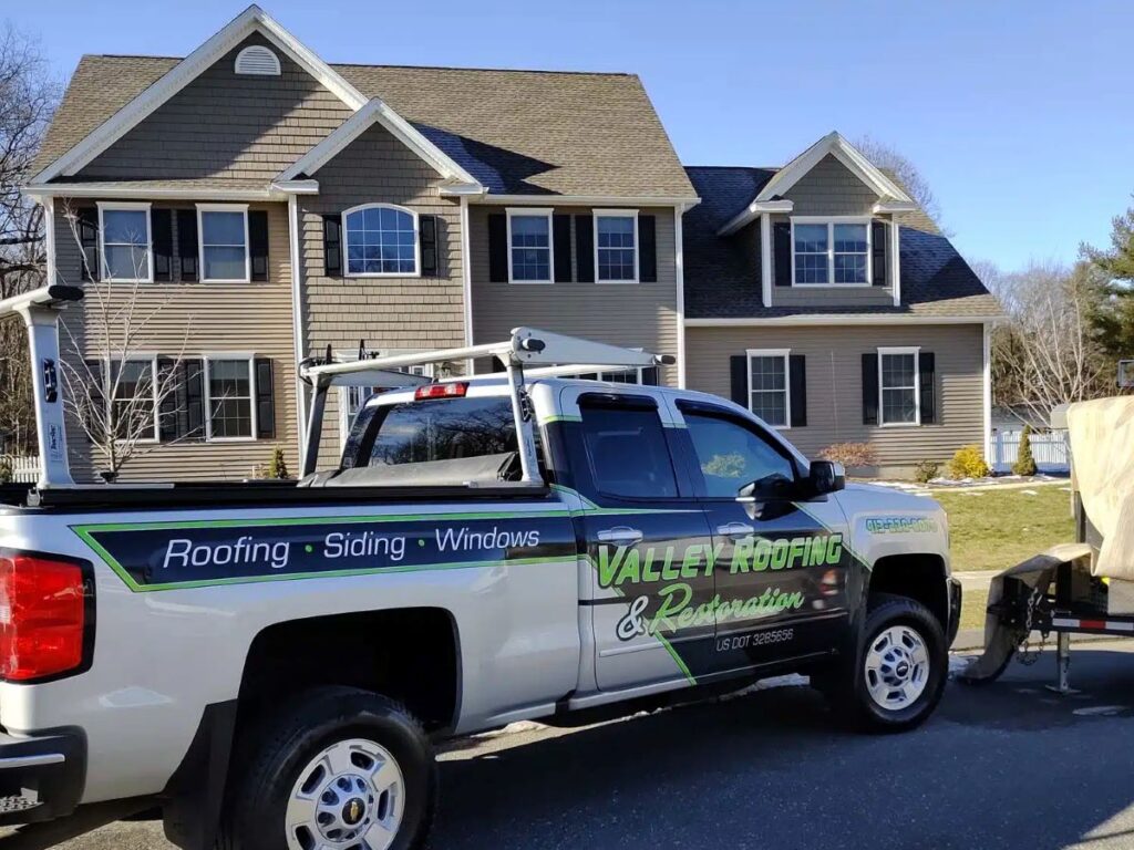 Valley Roofing and Restoration white truck parked outside house